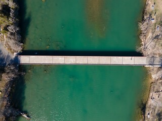 Aerial view of Mansfield Dam with crystal-clear blue water on a sunny day