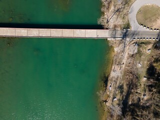 Aerial view of Mansfield Dam with crystal-clear blue water on a sunny day