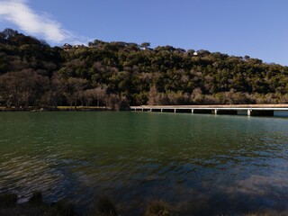 Aerial view of Mansfield Dam with crystal-clear blue water on a sunny day