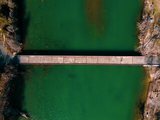 Aerial view of Mansfield Dam with crystal-clear blue water on a sunny day