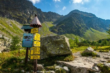 Colorful signpost set against a backdrop of rugged mountains. Western Tatras, Slovakia.