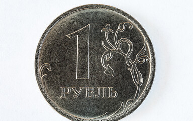Close-up of Russian one ruble coin on white background. Concept of money, finance, cooperation, budget, exchange rate and trade. Flat lay, macro, top view, mockup
