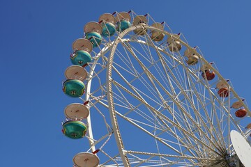 a ferris wheel against the sky with bright green and red balls