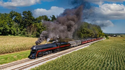 Aerial Front View of a Restored Antique Steam Passenger Train, Traveling Thru the Countryside