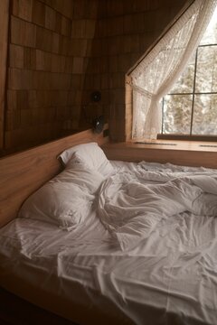 Closeup of a wooden bed during an early morning in winter