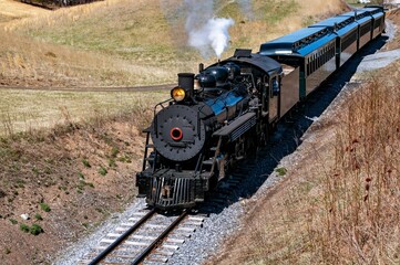 Front and Above View of an Approaching Restored Narrow Gauge Passenger Steam Train Blowing Smoke