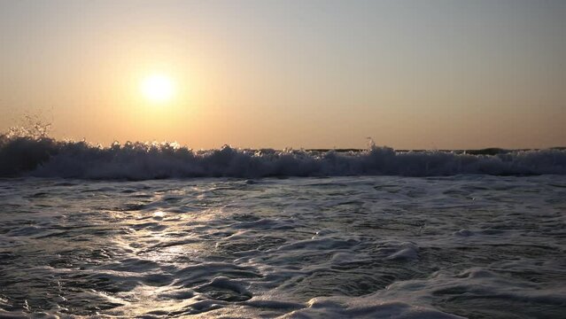 Sunset scene of sea waves with sun disk