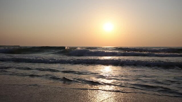 Beautiful view of sunset from the beach with sea waves