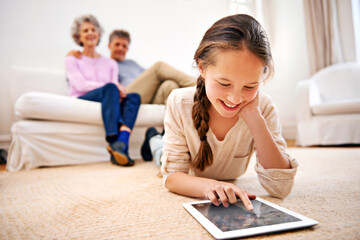Relax, kid or girl with tablet for elearning or studying for remote education on carpet at home. Family, grandfather or grandmother with a happy child reading ebook or streaming video or movie