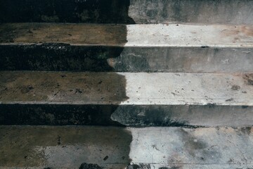 Aged staircase, featuring a cement base, as it ascends into the distance