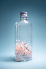 Groups of used hypodermic needles in a clear vial. Environmentally safe disposal of infectious waste