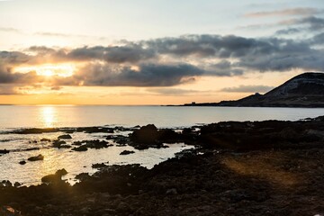 Picturesque sunrise over the sea in Bizerte, Tunisia with rocky outcroppings along the shoreline