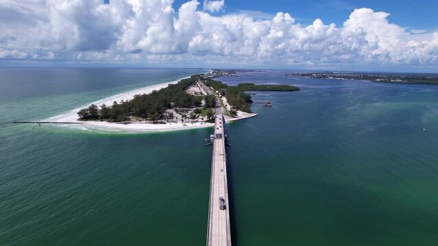 Landscape drone scene over cars on Cortez Bridge in Florida near trees Bradenton Beach