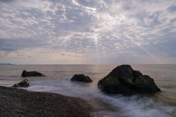 Water waves of the Black Sea crashing on rocks on the stony shore, coast - close up, nobody, no people. Nature, element, landscape