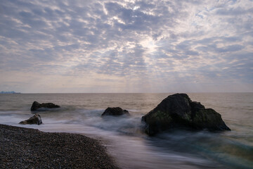 Water waves of the Black Sea crashing on rocks on the stony shore, coast - close up, nobody, no people. Nature, element, landscape