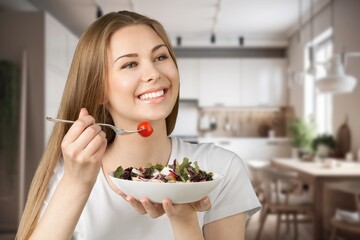 Happy young woman eats fresh fruits