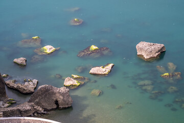 Water waves of the Black Sea crashing on rocks on the stony shore, coast - close up, nobody, no people. Nature, element, landscape
