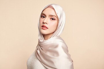 Beautiful young asian muslim woman wearing a white hijab on beige background, Portrait of Arab Beauty.