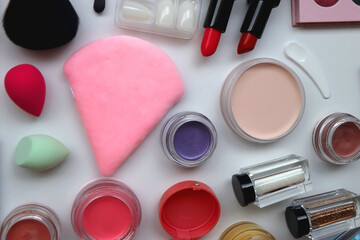 Various colorful beauty products on white background. Flat lay. 