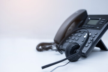 close up soft focus on telephone devices with copy space white background at office desk in...