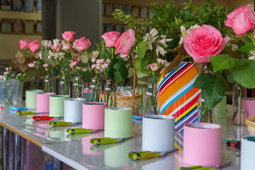 Preparing flowers for a master class on making bouquets in hat boxes. Teaching children floristry. No people.