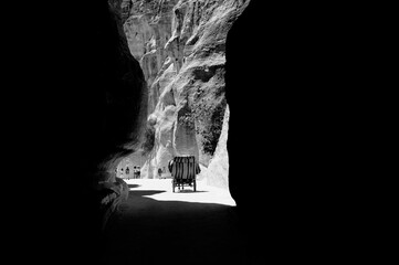 Horse-drawn carriage situated in the ancient city of Petra, surrounded by sandstone formations