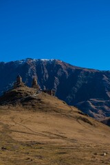 Fototapeta na wymiar View of an ancient castle situated atop a mountain in Kazbegi, Georgia