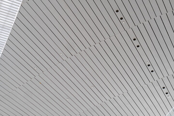 Lights and ventilation system in long line on ceiling of the industrial building. Exhibition Hall....