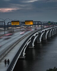 Bridge in Virginia with yellow warning banners against a backdrop of cloudy sky