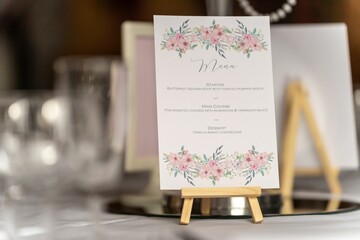 a table is set up with place settings and a menu