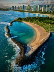 Scenic beach view of Ala Moana Beach, with crystal clear blue waters and white sand