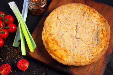 cherry tomato quiche, leek, dark wooden table, wooden board