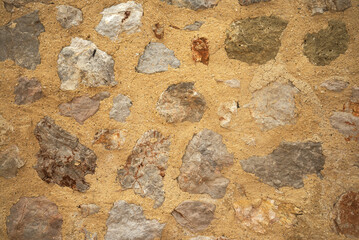 traditional stone wall in Greece made of brown and beige stone