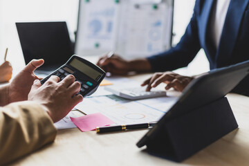 Business meeting, Financial advisors discuss investment chart analysis in company financial reports and are planning business finances.