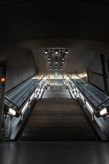 Illuminated staircase in an underground public transit station.