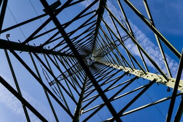 looking up at the top of a metal structure, with a sky in the background