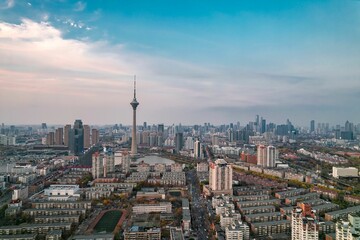 Fototapeta premium View of the Tianjin TV Tower and Water Park Complex near a body of water in China at sunset