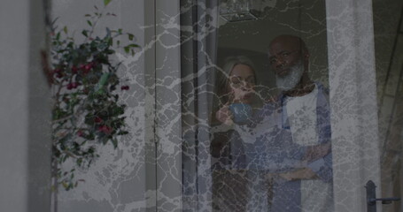 Image of moving background over sad senior diverse couple embracing