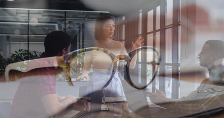 Image of glasses over diverse group of business people