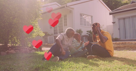 Image of falling hearts over happy african american family