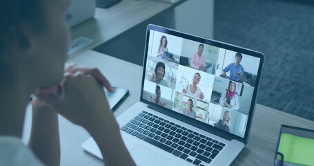 Image of world map and icons over african american woman having image call on laptop