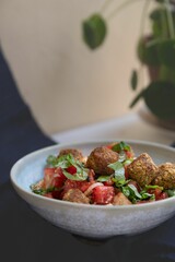 vegan salad with watermelon, feta cheese, green spring onions, tomatoes and falafel