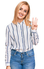 Beautiful caucasian woman wearing casual clothes showing and pointing up with fingers number three while smiling confident and happy.