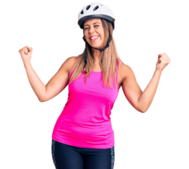 Young beautiful woman wearing bike helmet very happy and excited doing winner gesture with arms raised, smiling and screaming for success. celebration concept.
