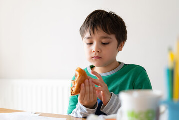 Preschool kid boy eating hamburger sitting in nursery cafe,Cute happy boy eating chicken burger for lunch,Healthy child eating delicious homemade food