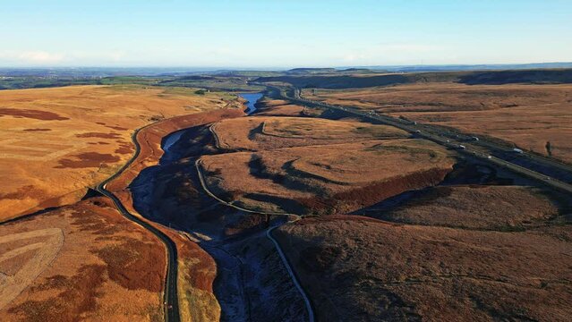 Drone footage of Saddleworth Moor, and motorway the M62  Windy Hill with blue sky in the summer