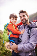 Father, child and hiking portrait with smile, backpack and travel with happy and support in nature. Kid, adventure and mountain with love, trust and bonding with family and journey for holiday