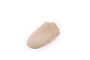 A beige bread-shaped object, the inner shape of a cardboard shoe, so as not to lose the shape of the shoe, on a white background.