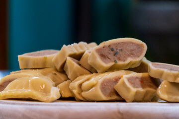 Fresh cut Maultaschen before cocking at pan with other ingredients