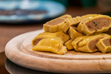 Fresh cut Maultaschen before cocking at pan with other ingredients